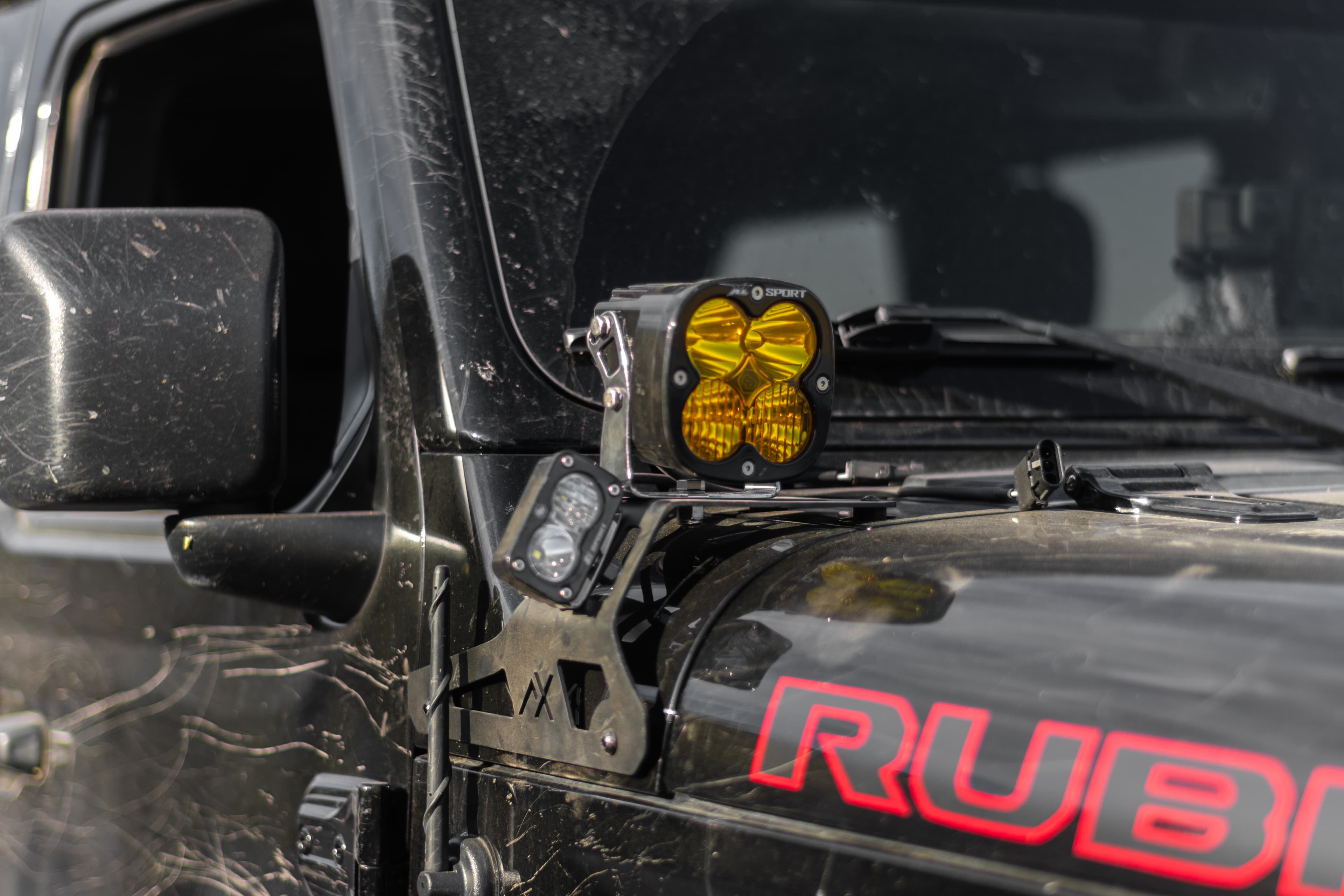 Close-up of a NomadX light bracket mounted on a red Jeep